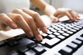 Photo of Hands Typing on Keyboard