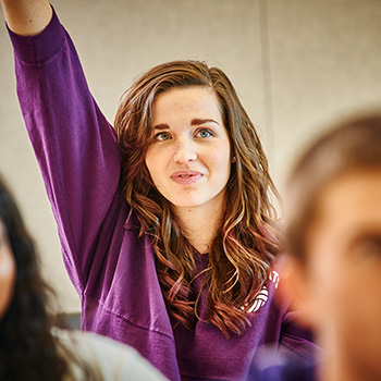 Female Student Raising Hand in Classroom