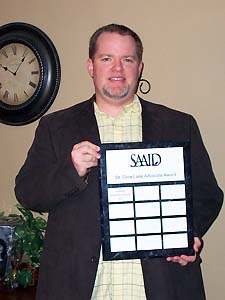 Photo of Joe Blasdel Holds Award 2012