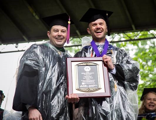 Dr. Guy Boysen, (right) professor of psychology at McKendree University, accepts the 2019 Grandy Faculty Award from Ryan Furniss, president of the Alumni Association.