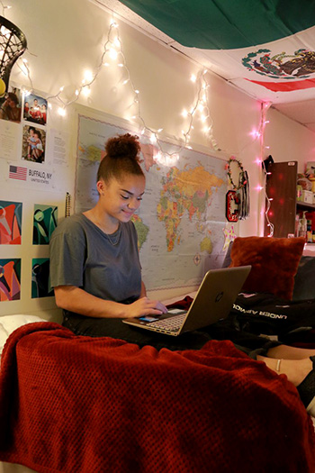 Female Student in Room on Laptop Computer