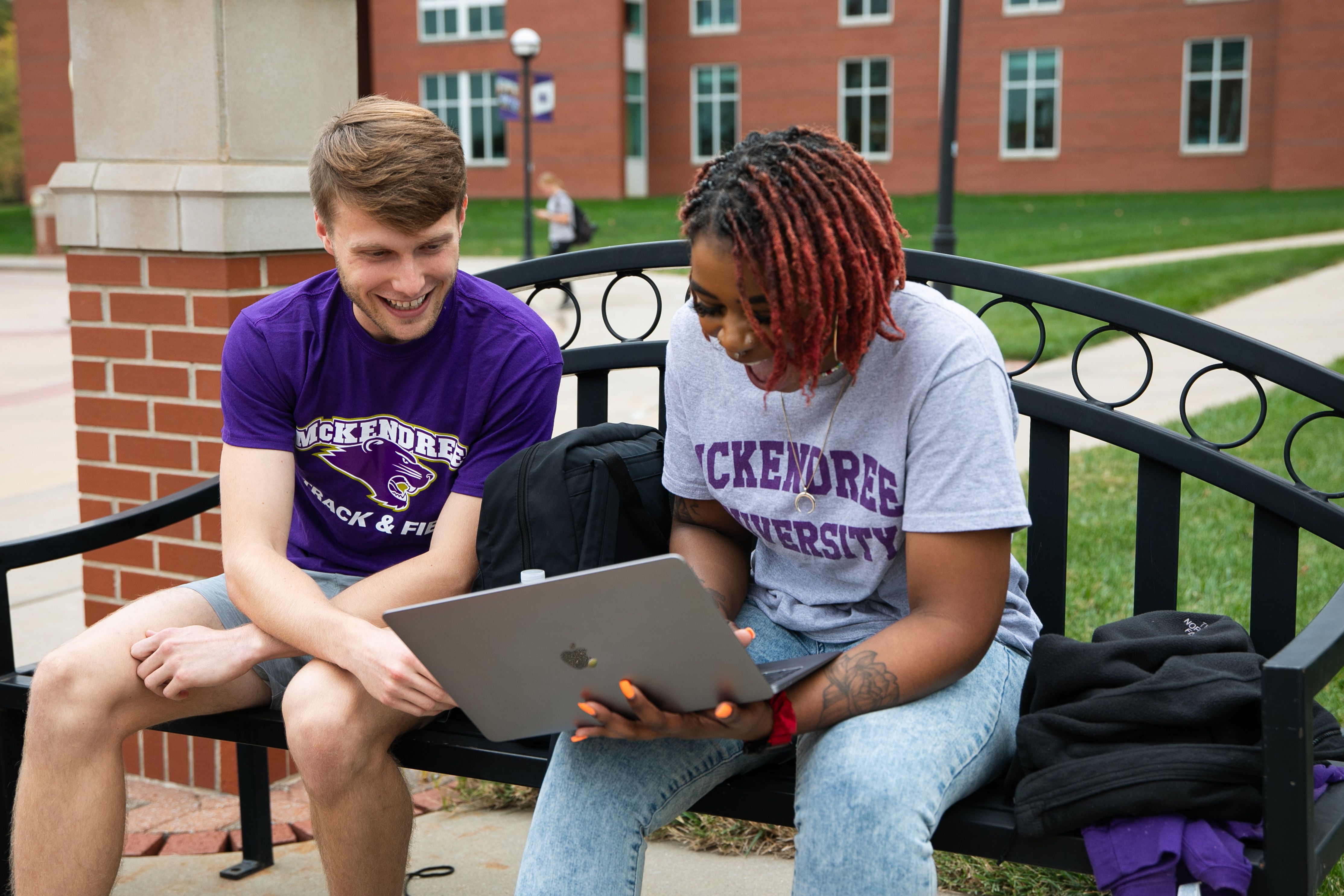 two students looking at laptop