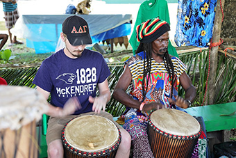 Student Playing Drums with Local