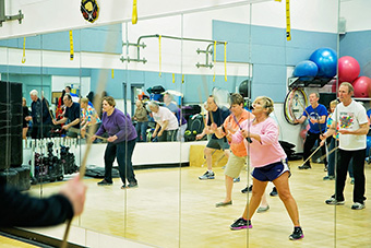 Stacie (Panek) King ’14 leads her Rock Steady boxers through exercises to improve their balance, coordination, agility, strength, focus and rhythm.