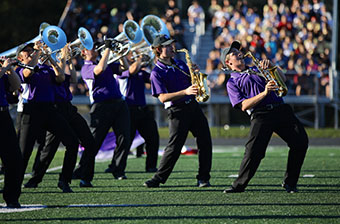 The Marching Bearcat Band performs the “Bearcat Boogie” on the football field.