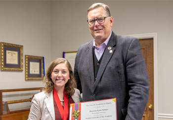 Breanna Sampo and President Dobbins with Award